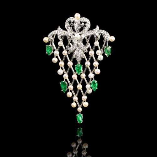 A gold emerald diamonds and pearl fishnet pendant.
